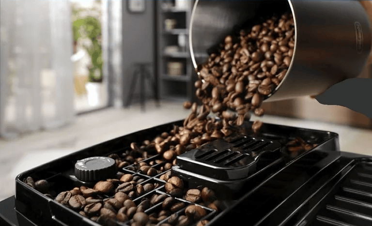 Adding coffee beans to the De’Longhi Magnifica S hopper